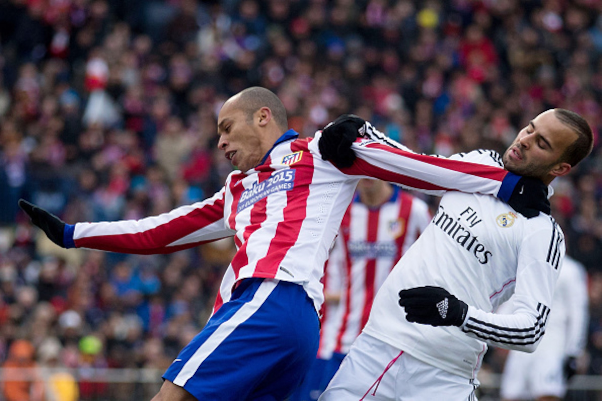 MADRID, SPAIN - FEBRUARY 07: Joao Miranda (L) of Atletico de Madrid and Jese Rodriguez (R) of Real Madrid CF hang themselves during the La Liga match between Club Atletico de Madrid and Real Madrid CF at Vicente Calderon Stadium on February 7, 2015 in Mad