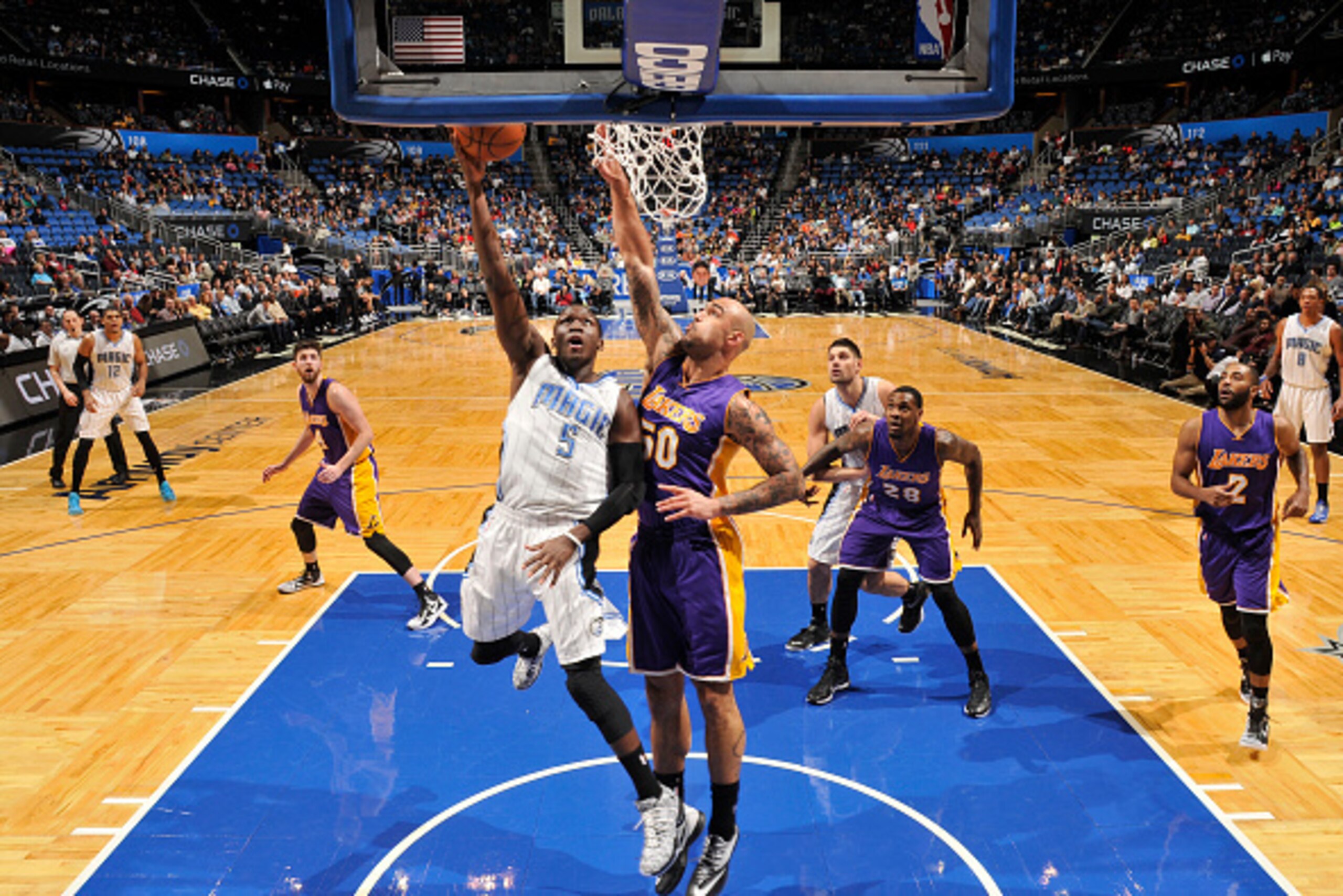 ORLANDO, FL -  FEBRUARY 6: Victor Oladipo #5 of the Orlando Magic goes for the lay up against Robert Sacre #50 of the Los Angeles Lakers during the game on February 6, 2015 at Amway Center in Orlando, Florida . NOTE TO USER: User expressly acknowledges an