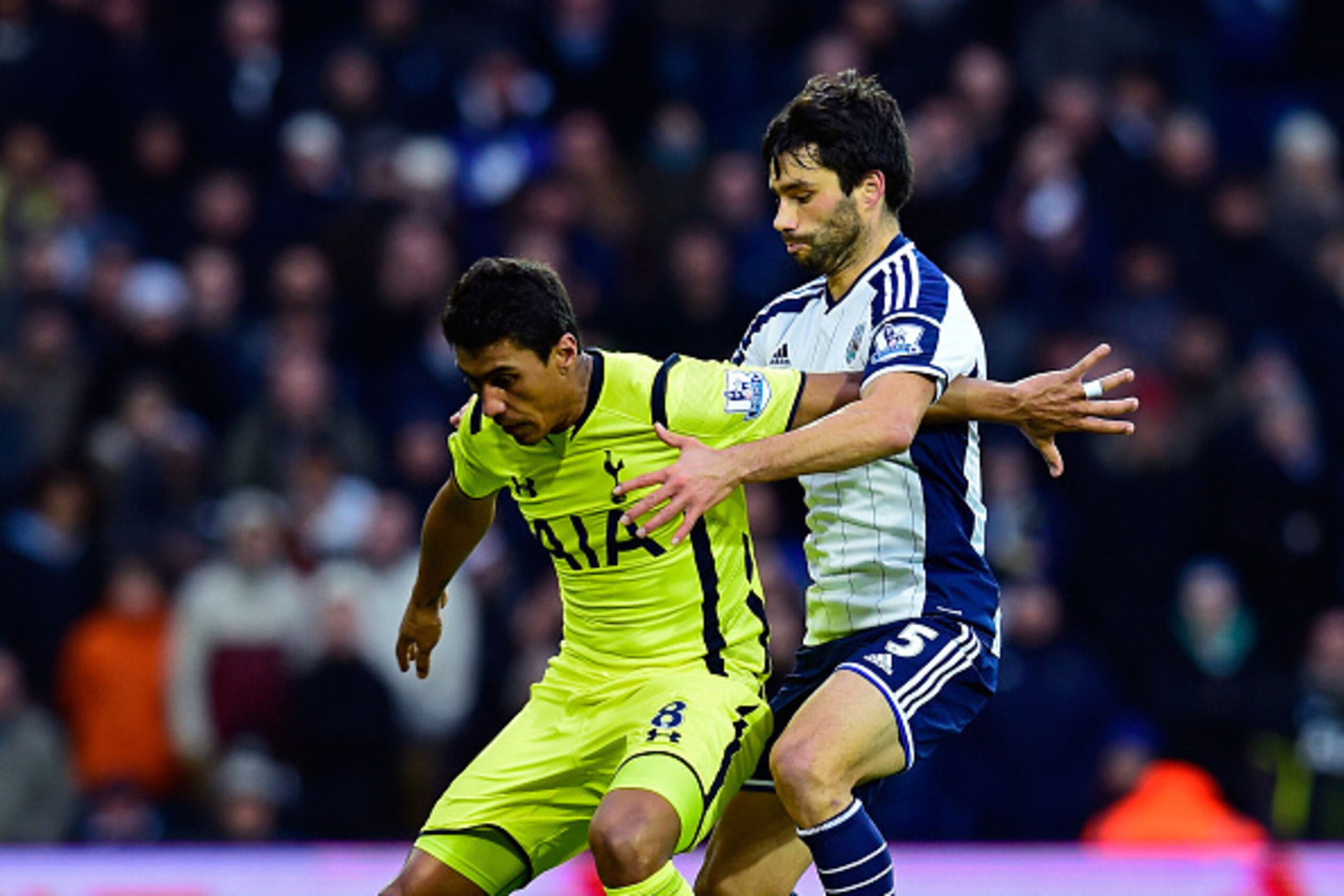 WEST BROMWICH, ENGLAND - JANUARY 31: Paulinho of Spurs holds off the challenge Claudio Yacob of West Brom during the Barclays Premier League match between West Bromwich Albion and Tottenham Hotspur at The Hawthorns on January 31, 2015 in West Bromwich, E WEST BROMWICH, ENGLAND - JANUARY 31: Paulinho of Spurs holds off the challenge Claudio Yacob of West Brom during the Barclays Premier League match between West Bromwich Albion and Tottenham Hotspur at The Hawthorns on January 31, 2015 in West Bromwich, E