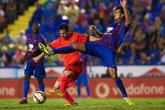 VALENCIA, SPAIN - SEPTEMBER 21:  Lionel Messi (L) of Barcelona is tackled by Hector Rodas of Levante during the La Liga match between Levante UD and FC Barcelona at Ciutat de Valencia on September 21, 2014 in Valencia, Spain.  (Photo by Manuel Queimadelos