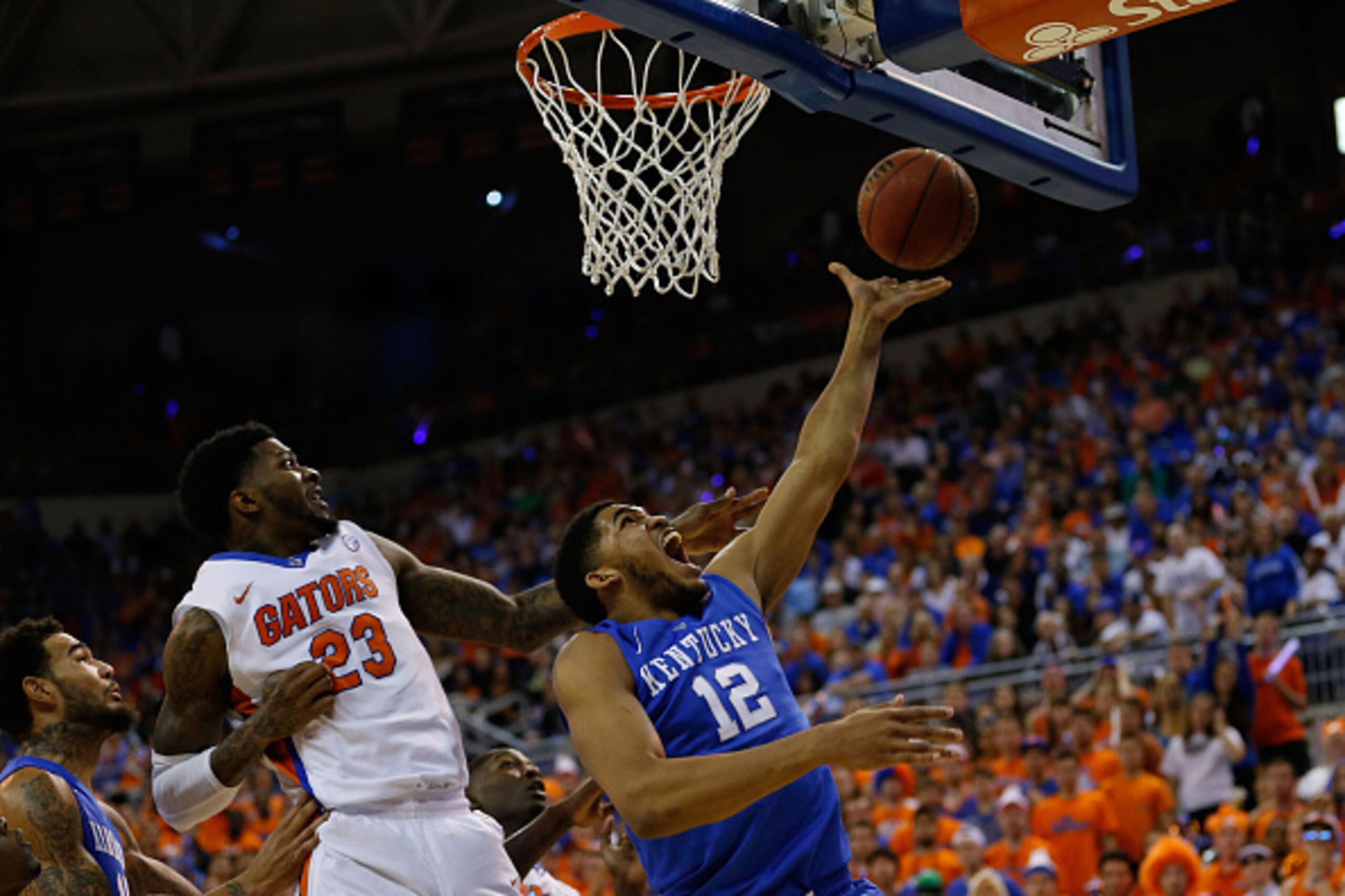 GAINESVILLE, FL - FEBRUARY 07:  Karl-Anthony Towns #12 of the Kentucky Wildcats shoots a basket around Chris Walker #23 of the Florida Gators during the first half of the game at Stephen C. O'Connell Center on February 7, 2015 in Gainesville, Florida.  (P