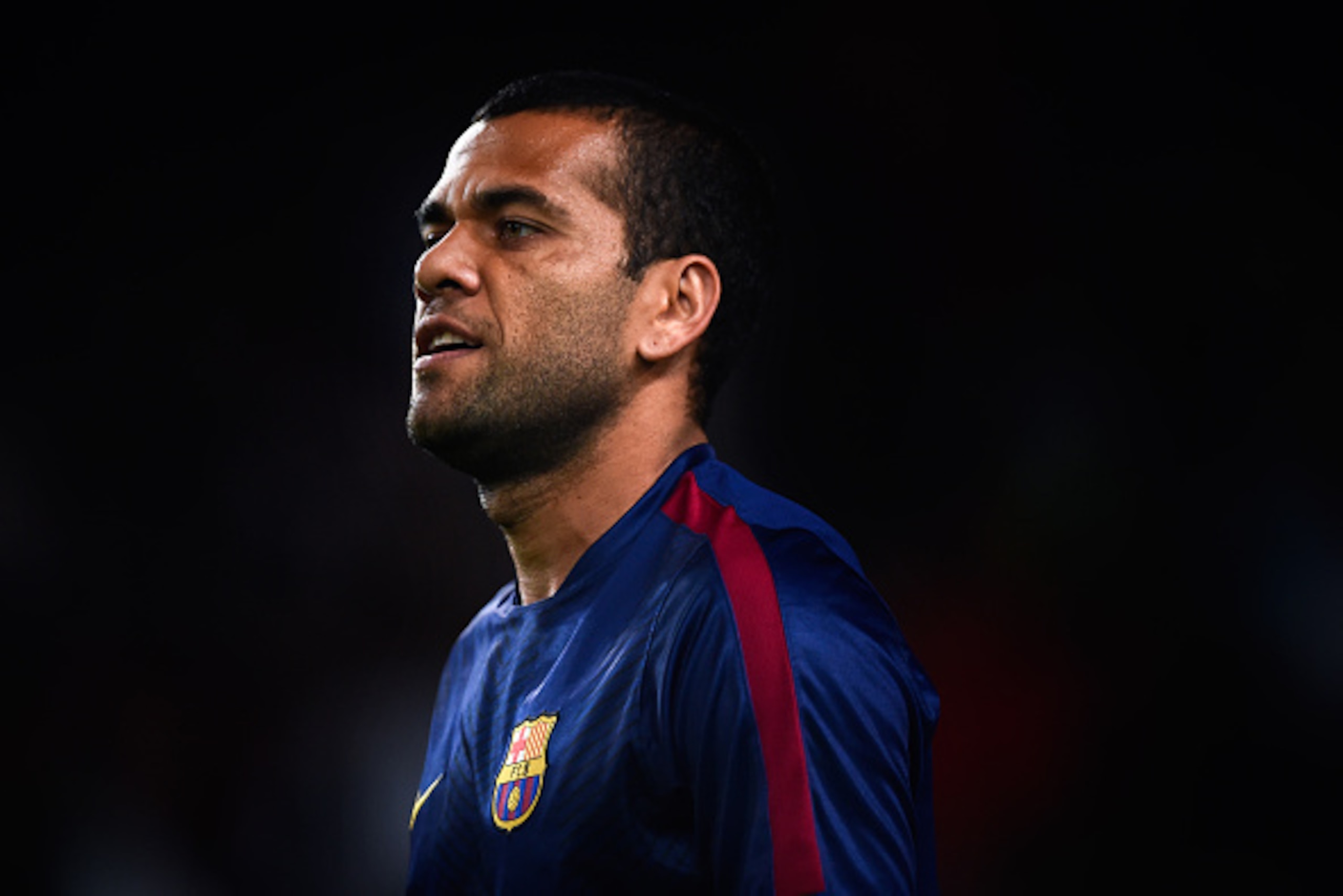 BARCELONA, SPAIN - NOVEMBER 22:  Dani Alves of FC Barcelona looks on  during the warm-up prior to the La Liga match between FC Barcelona and Sevilla FC at Camp Nou on November 22, 2014 in Barcelona, Spain. Lionel Messi beat the  number of goal in the Span