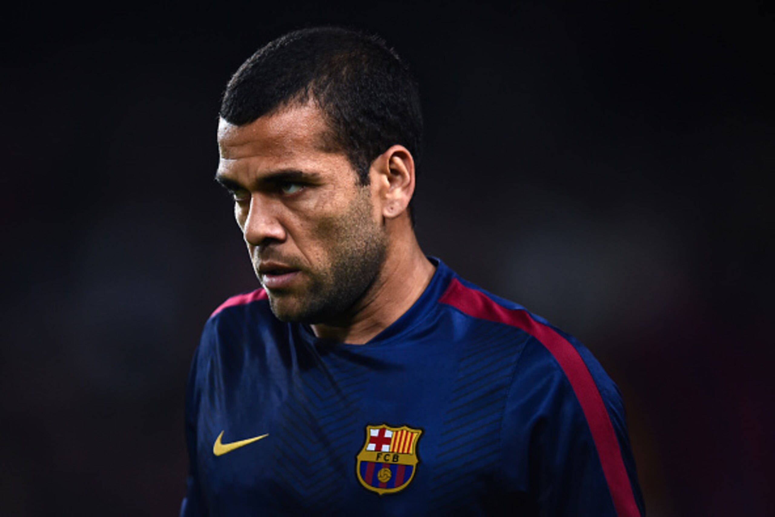 BARCELONA, SPAIN - NOVEMBER 22: Dani Alves of FC Barcelona looks on during the warm-up prior to the La Liga match between FC Barcelona and Sevilla FC at Camp Nou on November 22, 2014 in Barcelona, Spain. Lionel Messi beat the number of goal in the Span BARCELONA, SPAIN - NOVEMBER 22: Dani Alves of FC Barcelona looks on during the warm-up prior to the La Liga match between FC Barcelona and Sevilla FC at Camp Nou on November 22, 2014 in Barcelona, Spain. Lionel Messi beat the number of goal in the Span