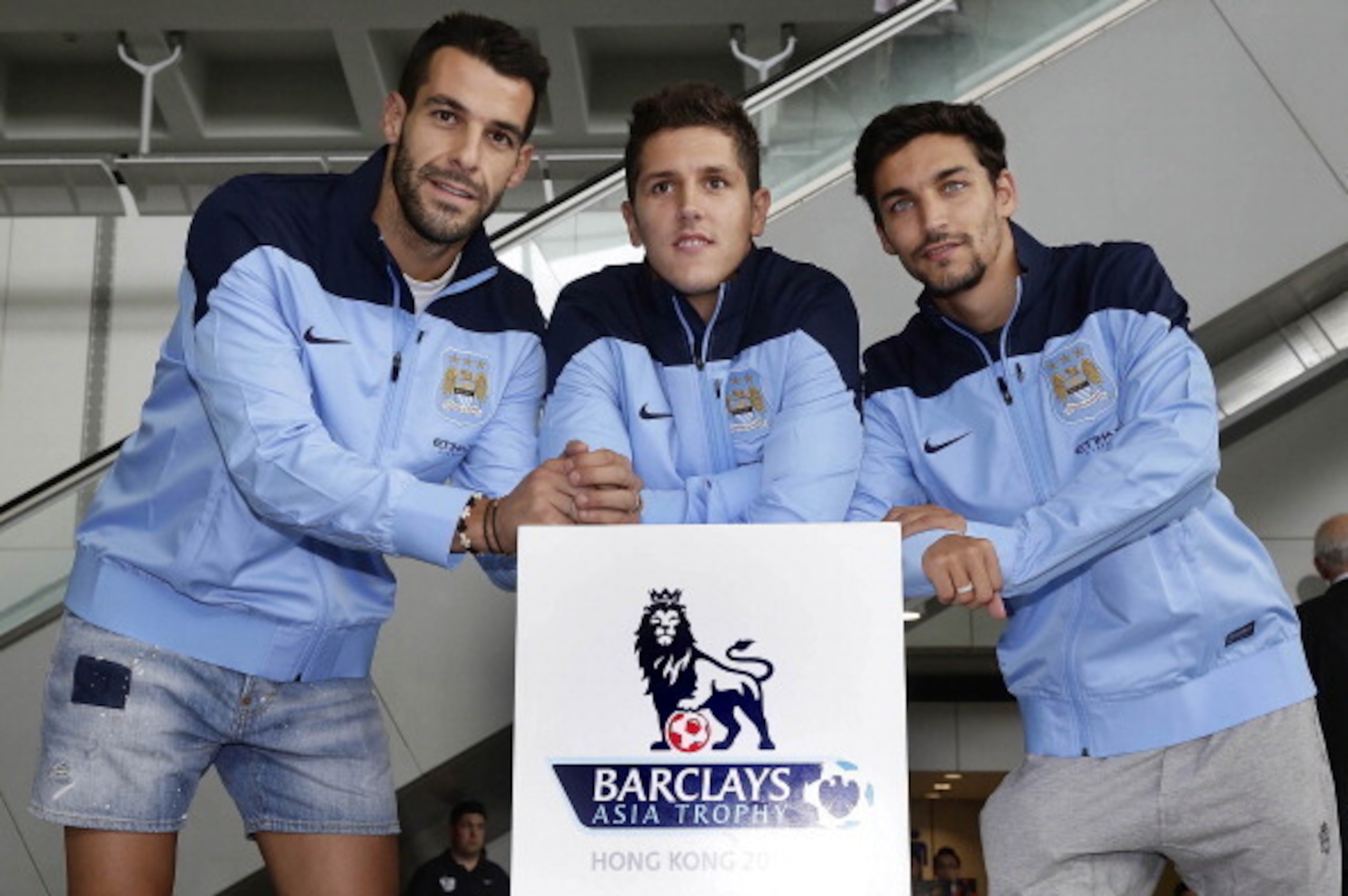 HONG KONG - JULY 22:  (L-R) Newly signed Manchester City players Alvaro Negredo, Stevan Jovetic and Jesus Navas pose for a  photo at Hong Kong Airport as they arrive to compete in the Barclays Asia Trophy, on July 22, 2013 in Hong Kong. (Photo by Jessica 