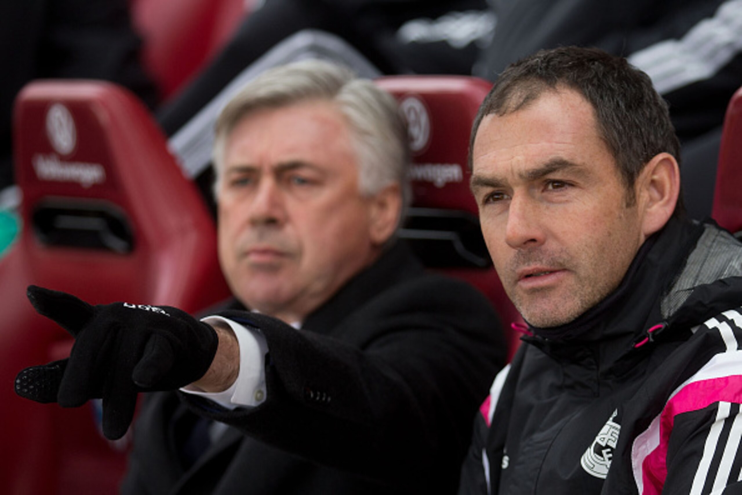 MADRID, SPAIN - FEBRUARY 07: Assistant coach Paul Clement of Real Madrid CF looks on as head coach Carlo Ancelotti  gives instructions prior to start the La Liga match between Club Atletico de Madrid and Real Madrid CF at Vicente Calderon Stadium on Febru