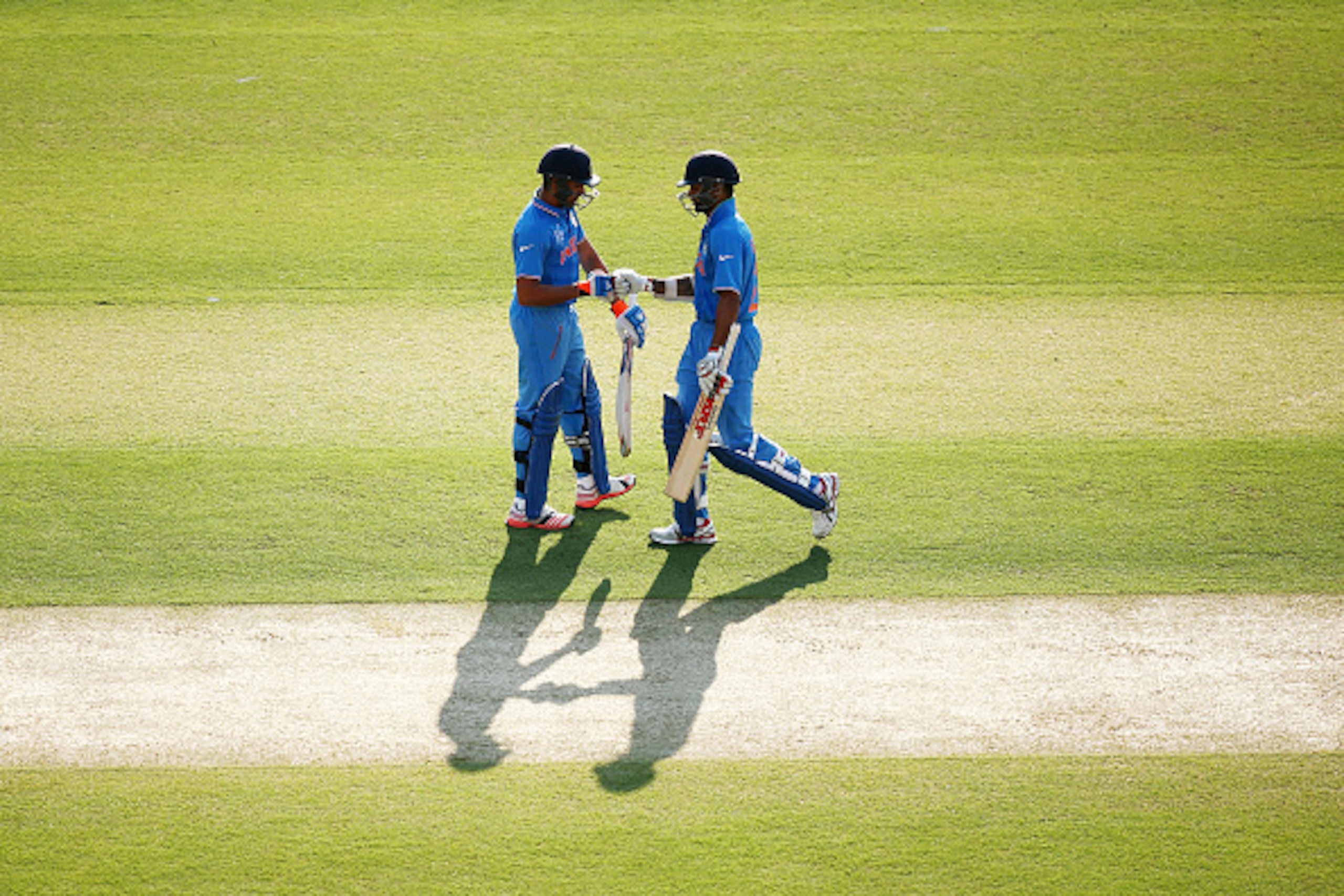 ADELAIDE, AUSTRALIA - FEBRUARY 08: Shikhar Dhawan and Rohit Sharma of India speak between overs during the ICC Cricket World Cup warm up match between Australia and India at Adelaide Oval on February 8, 2015 in Adelaide, Australia.  (Photo by Morne de Kle