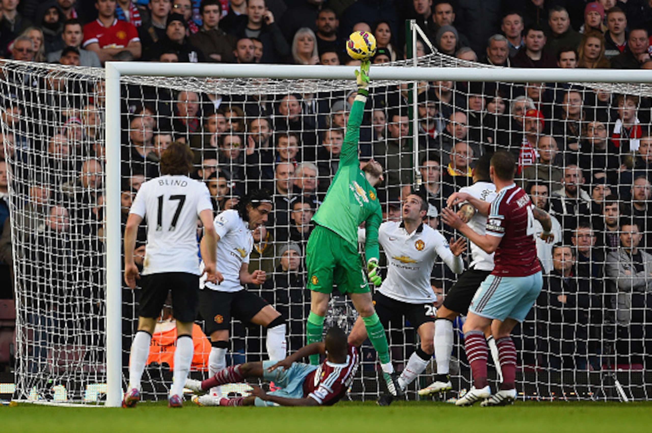 LONDON, ENGLAND - FEBRUARY 08:  David De Gea of Manchester United makes a save from Enner Valencia of West Ham during the Barclays Premier League match between West Ham United and Manchester United at Boleyn Ground on February 8, 2015 in London, England. 