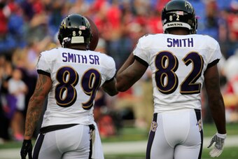 BALTIMORE, MD - AUGUST 07:  Wide receivers Steve Smith #89 (L) and Torrey Smith #82 of the Baltimore Ravens warm up before the start of an NFL pre-season game against the San Francisco 49ers at M&T Bank Stadium on August 7, 2014 in Baltimore, Maryland.  (