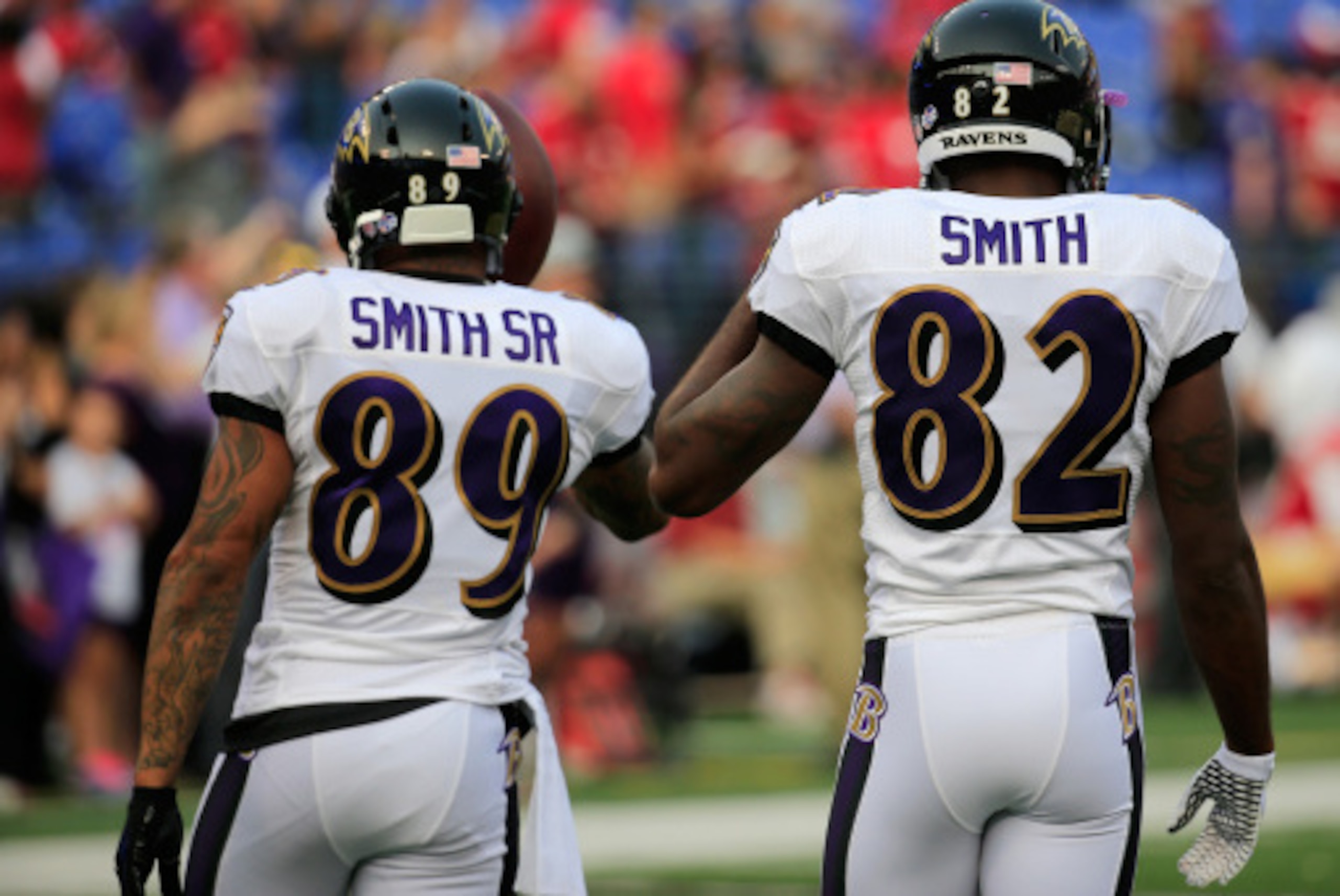 BALTIMORE, MD - AUGUST 07:  Wide receivers Steve Smith #89 (L) and Torrey Smith #82 of the Baltimore Ravens warm up before the start of an NFL pre-season game against the San Francisco 49ers at M&T Bank Stadium on August 7, 2014 in Baltimore, Maryland.  (