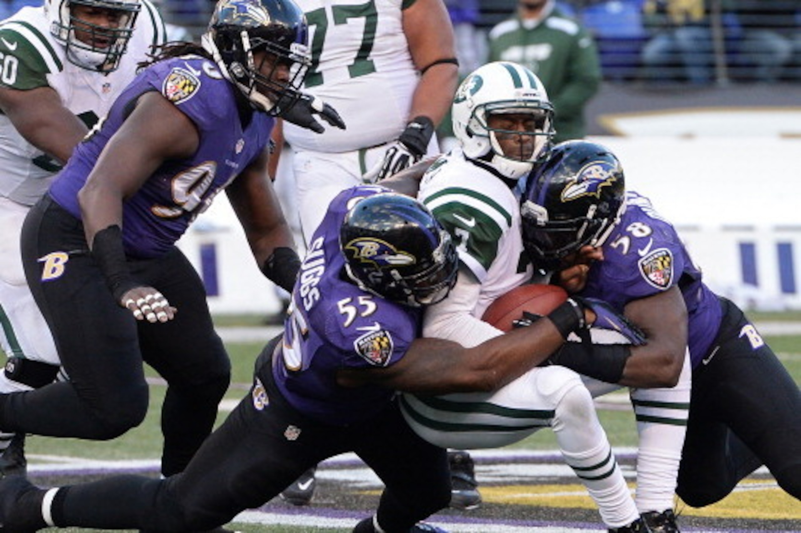 BALTIMORE, MD - NOVEMBER 24: Quarterback Geno Smith #7 of the New York Jets is sacked by outside linebacker Terrell Suggs #55 and Elvis Dumervil #58 of the Baltimore Ravens in the fourth quarter at M&T Bank Stadium on November 24, 2013 in Baltimore, Maryl