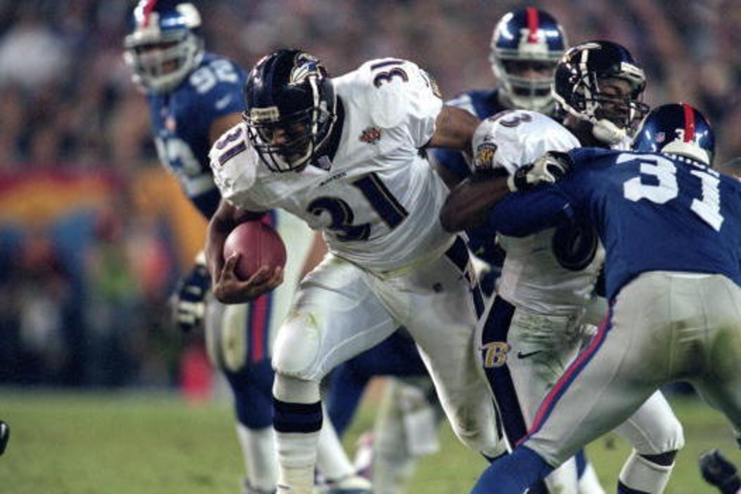 28 Jan 2001:  Jamal Lewis #31 of the Baltimore Ravens breaks through the defensive line during the Super Bowl XXXV Game against the New York Giants at the Raymond James Stadium in Tampa, Florida. The Ravens defeated the Giants 34-7.Mandatory Credit: Andy 