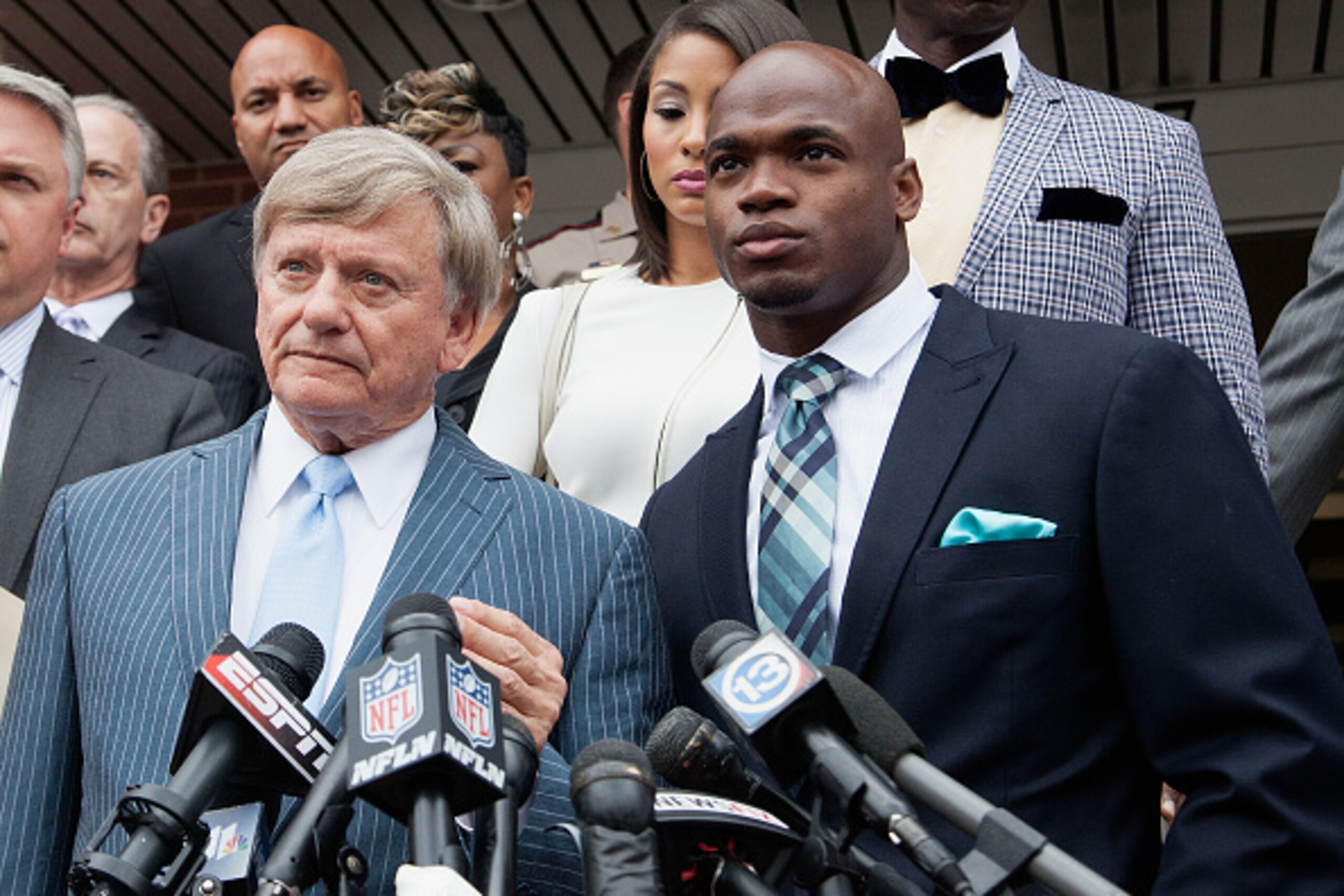 CONROE, TX - NOVEMBER 04:  Defense attorney Rusty Hardin, (L) and NFL running back Adrian Peterson of the of the Minnesota Vikings address the media after Peterson plead 'no contest' to a lesser misdemeanor charge of reckless assault on November 4, 2014 i