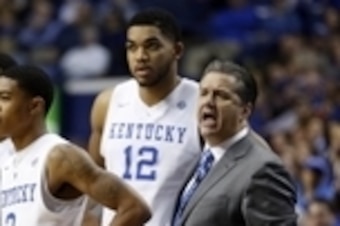 Jan 20, 2015; Lexington, KY, USA; Kentucky Wildcats head coach John Calipari reacts in the huddle with guard Tyler Ulis (3) guard Andrew Harrison (5) and forward Karl-Anthony Towns (12) during the game against the Vanderbilt Commodores in the second half 