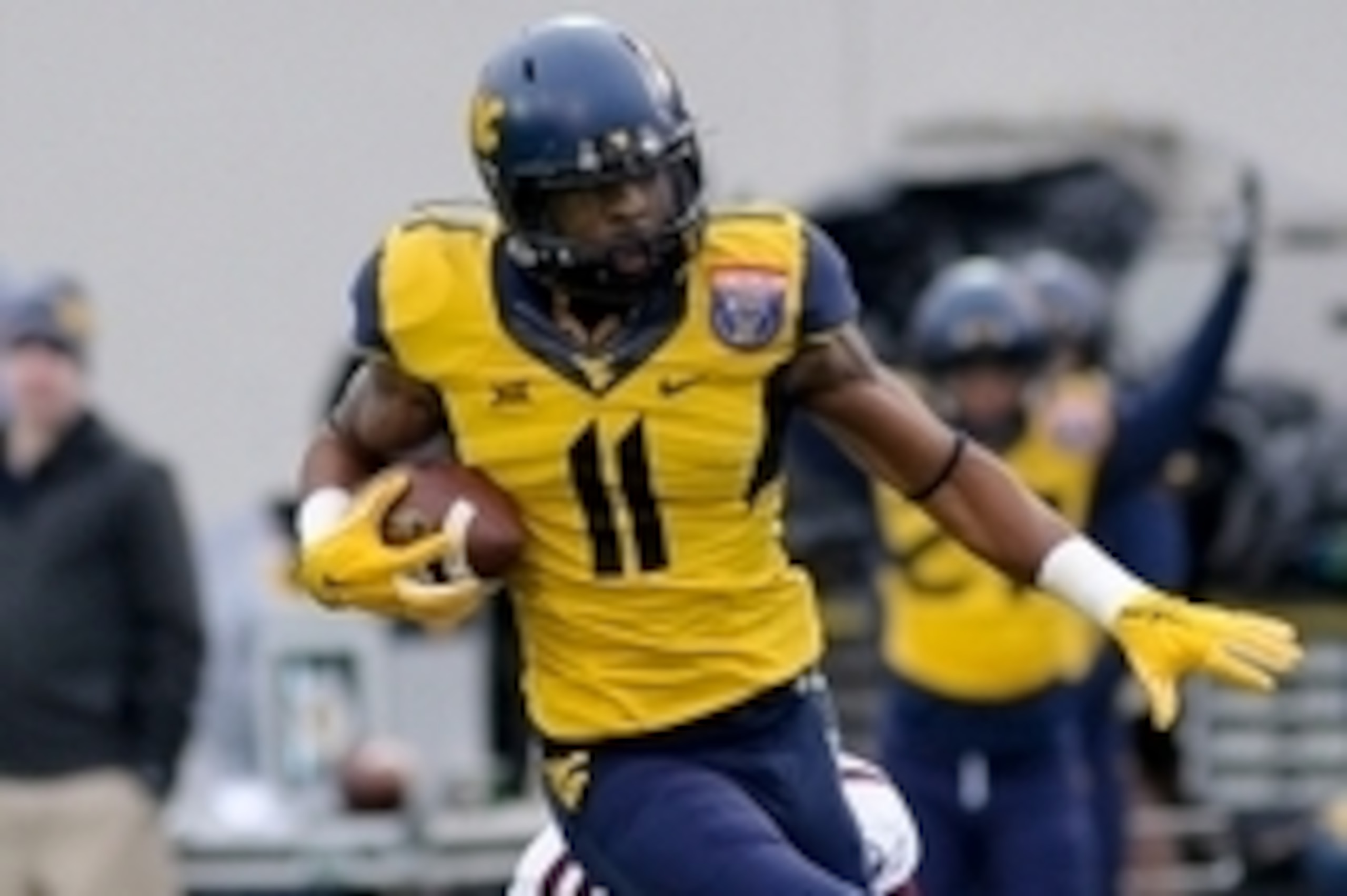 Dec 29, 2014; Memphis, TN, USA; West Virginia Mountaineers wide receiver Kevin White (11) is tackled by Texas A&M Aggies defensive back De'Vante Harris (1) during the game in the 2014 Liberty Bowl at Liberty Bowl Memorial Stadium. Texas A&M Aggies beat We