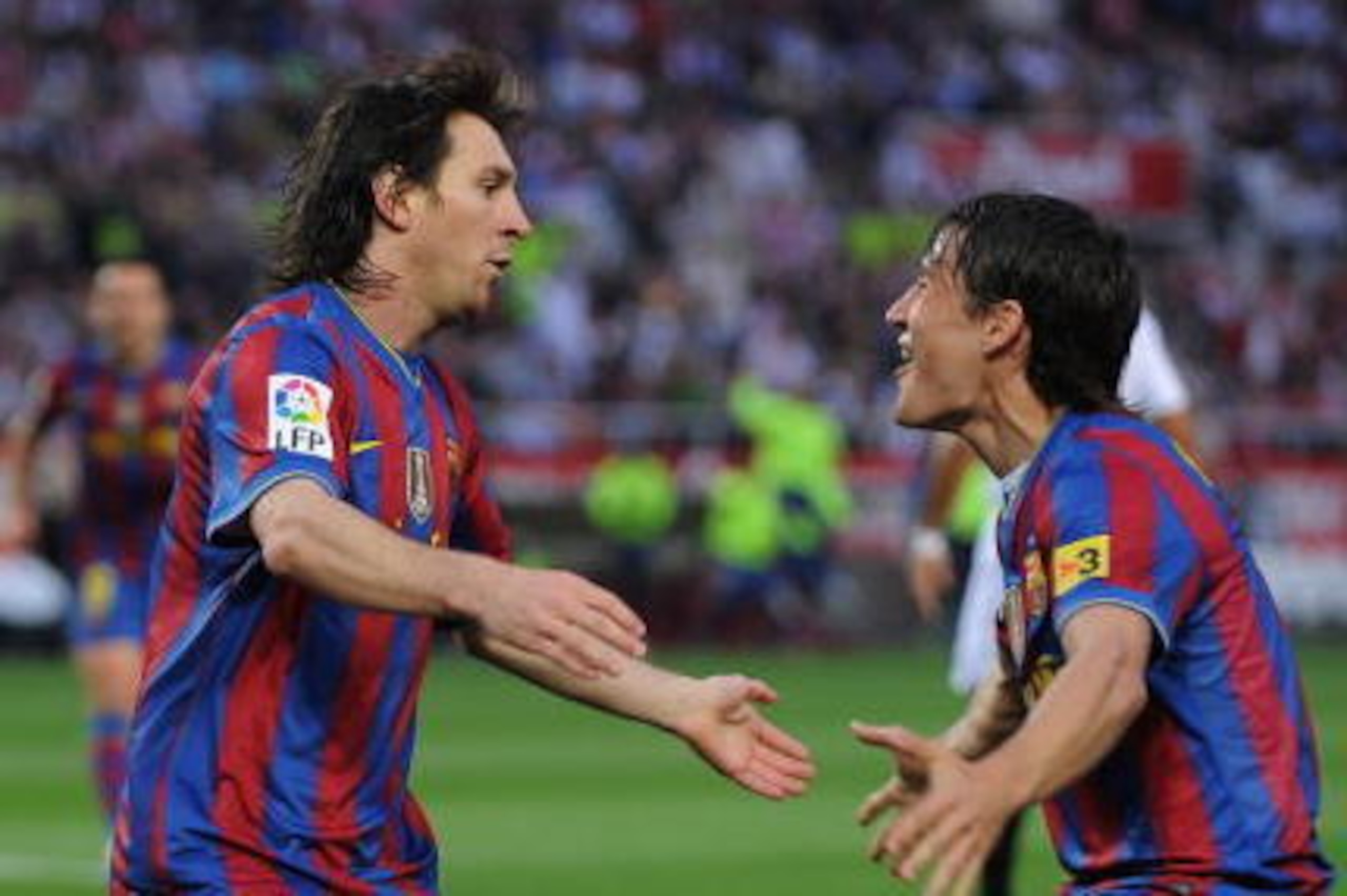 SEVILLE, SPAIN - MAY 08:  Lionel Messi (L) of Barcelona celebrates with Bojan Krkic after scoring his team's first goal during the La Liga match between Sevilla and Barcelona at Estadio Ramon Sanchez Pizjuan on May 8, 2010 in Seville, Spain.  (Photo by De