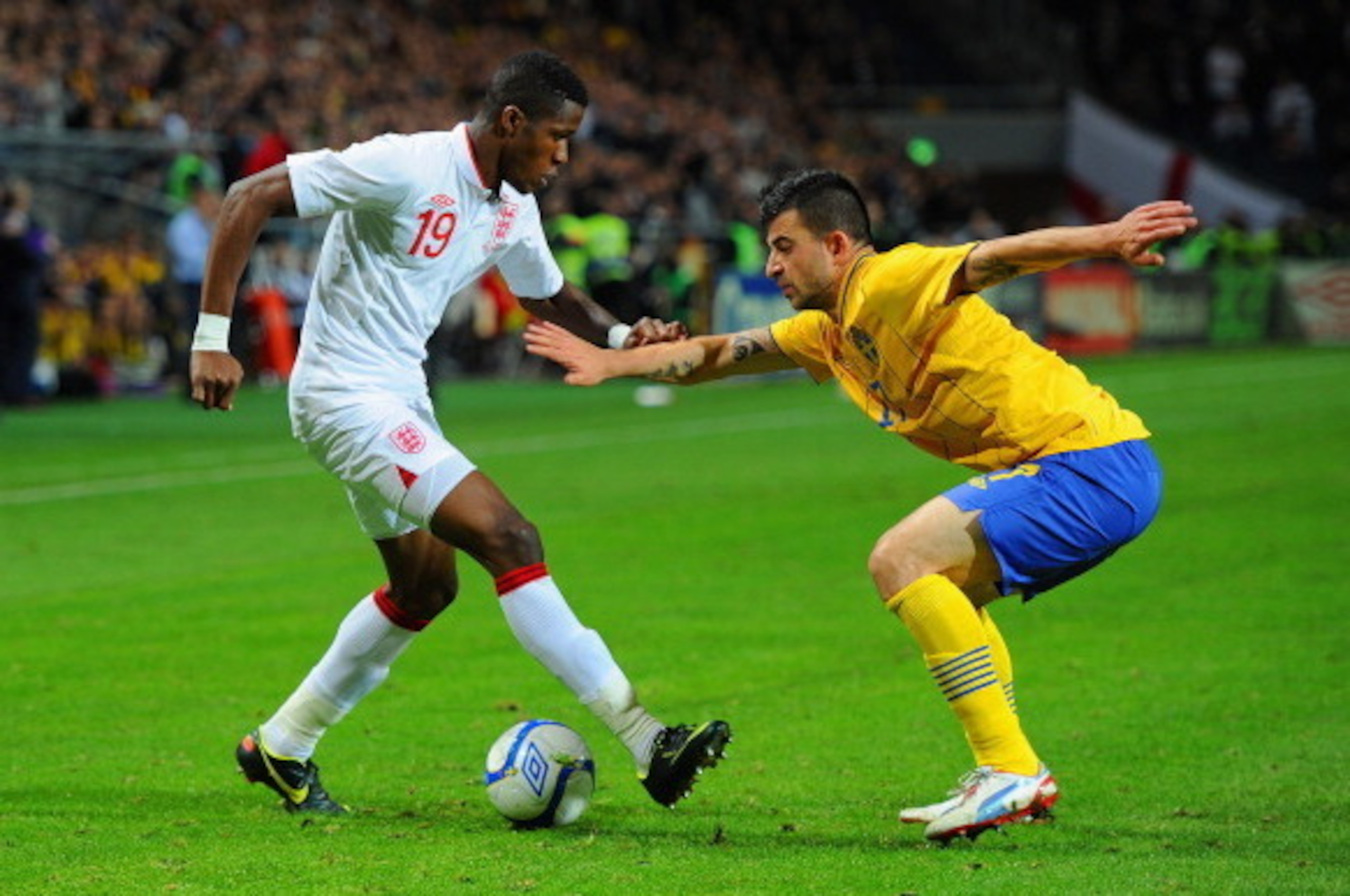STOCKHOLM, SWEDEN - NOVEMBER 14:  Wilfried Zaha of England in action with Behrangt Safari of Sweden during the international friendly match between Sweden and England at the Friends Arena on November 14, 2012 in Stockholm, Sweden.  (Photo by Michael Regan