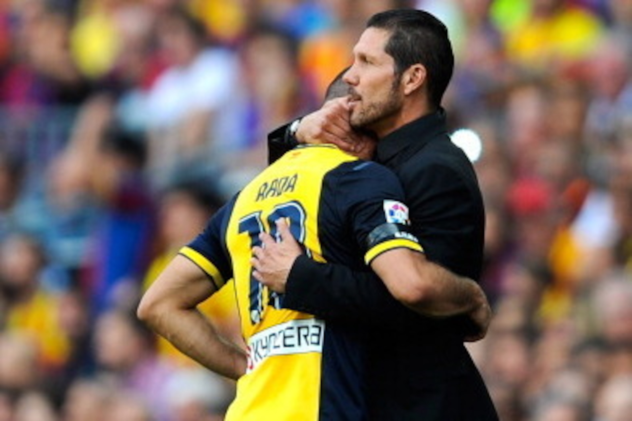 BARCELONA, SPAIN - MAY 17: Head coach Diego Pablo Simeone of Atletico de Madrid hugs his player Arda Turan as he leaves the pitch injured during the La Liga match between FC Barcelona and Club Atletico de Madrid at Camp Nou on May 17, 2014 in Barcelona, S