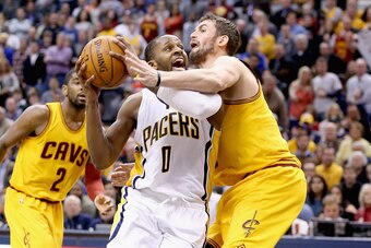 INDIANAPOLIS, IN - FEBRUARY 06:  C.J. Miles #0 of the Indiana Pacers shoots the ball while fouled by Kevin Love #0 of the Cleveland Cavaliers during the game at Bankers Life Fieldhouse on February 6, 2015 in Indianapolis, Indiana. NOTE TO USER: User expre