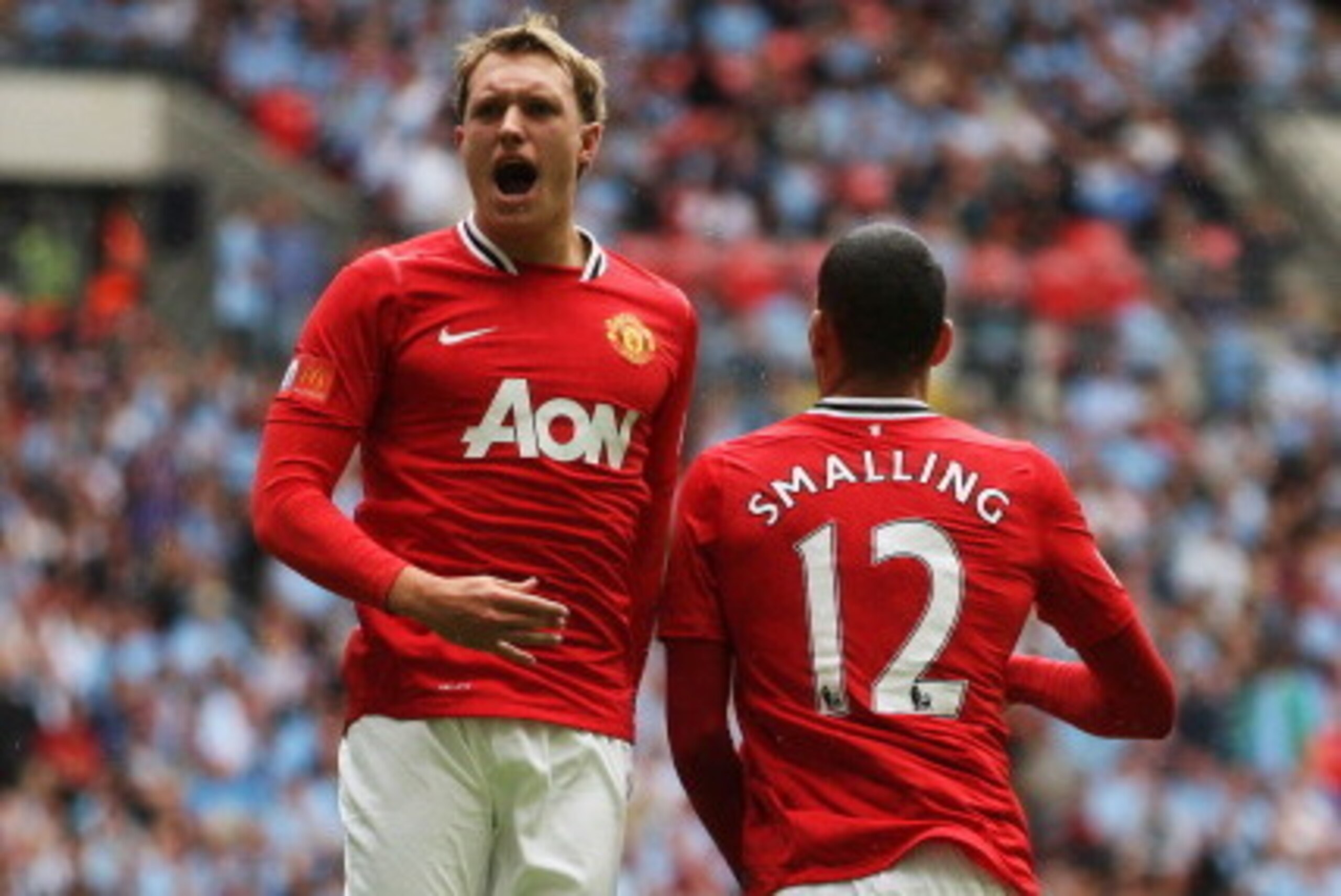 LONDON, ENGLAND - AUGUST 07:  Phil Jones of Manchester United celebrates with goalscorer Chris Smalling during the FA Community Shield match sponsored by McDonald's between Manchester City and Manchester United at Wembley Stadium on August 7, 2011 in Lond
