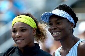 MONTREAL, QC - AUGUST 09:  (L-R) Serena Williams of the USA and Venus Williams of the USA pose before their women's semifinals match in the Rogers Cup at Uniprix Stadium on August 9, 2014 in Montreal, Canada.  (Photo by Streeter Lecka/Getty Images)
