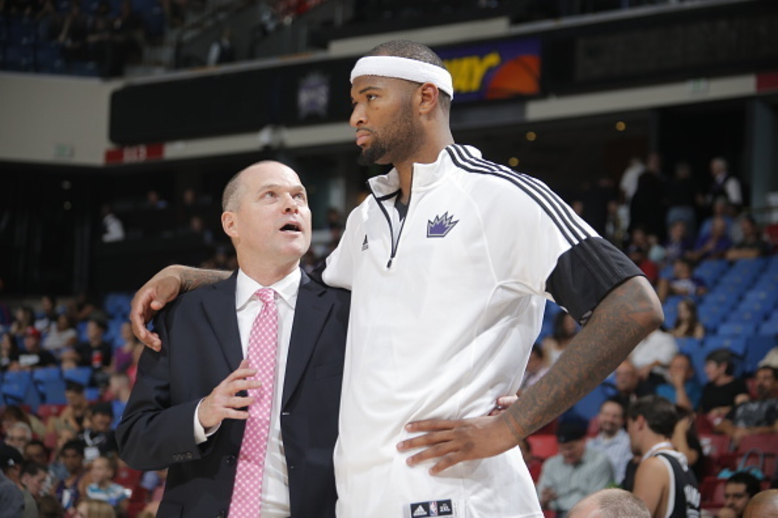 SACRAMENTO, CA - October 7: Head Coach of the Sacramento Kings Michael Malone speaks to DeMarcus Cousins #15 during a game against the Toronto Raptors at the Sleep Train Arena in Sacramento, California on October 7, 2014. NOTE TO USER: User expressly ackn