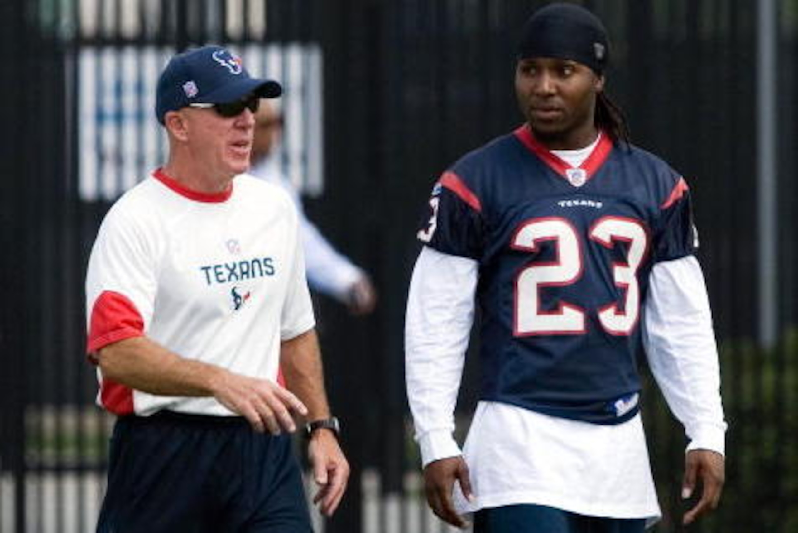 HOUSTON - MAY 09:  Cornerback Dunta Robinson #23 of the Houston Texans arrives at afternoon mini camp session with defensive backs coach Jon Hoke on May 9, 2008 at Reliant Park in Houston, Texas.  (Photo by Bob Levey/Getty Images)