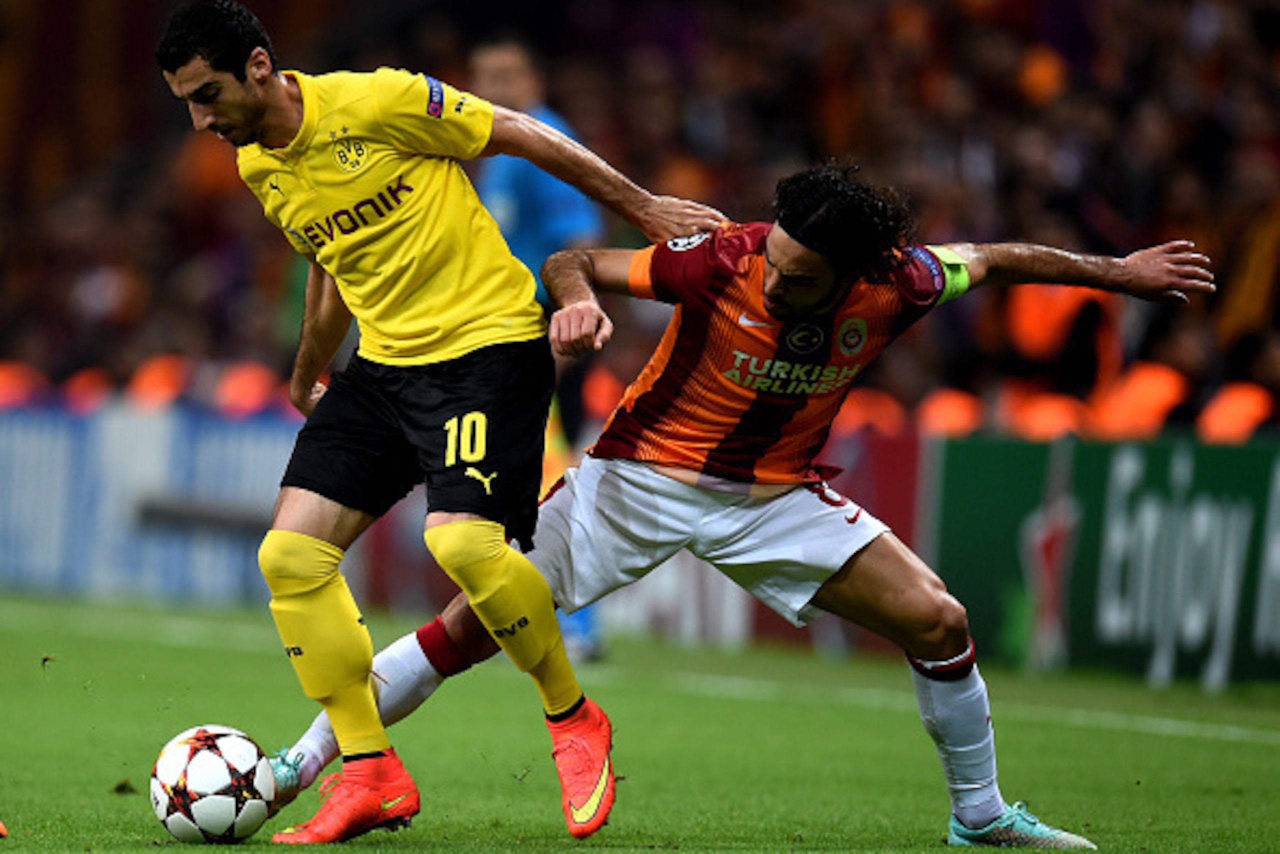 ISTANBUL, TURKEY - OCTOBER 22:  Henrikh Mkhitaryan of Borussia Dortmund is challenged by Selcuk Inan of Galatasaray during UEFA Champions League Group D match between Galatasaray and Borussia Dortmund at Turk Telekom Arena on October 22, 2014 in Istanbul,