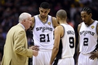 Jun 8, 2014; San Antonio, TX, USA; San Antonio Spurs head coach Gregg Popovich talks to forward Tim Duncan (21) guard Tony Parker (9) and forward Kawhi Leonard (2) against the Miami Heat in game two of the 2014 NBA Finals at AT&T Center. The Heat won 98-9