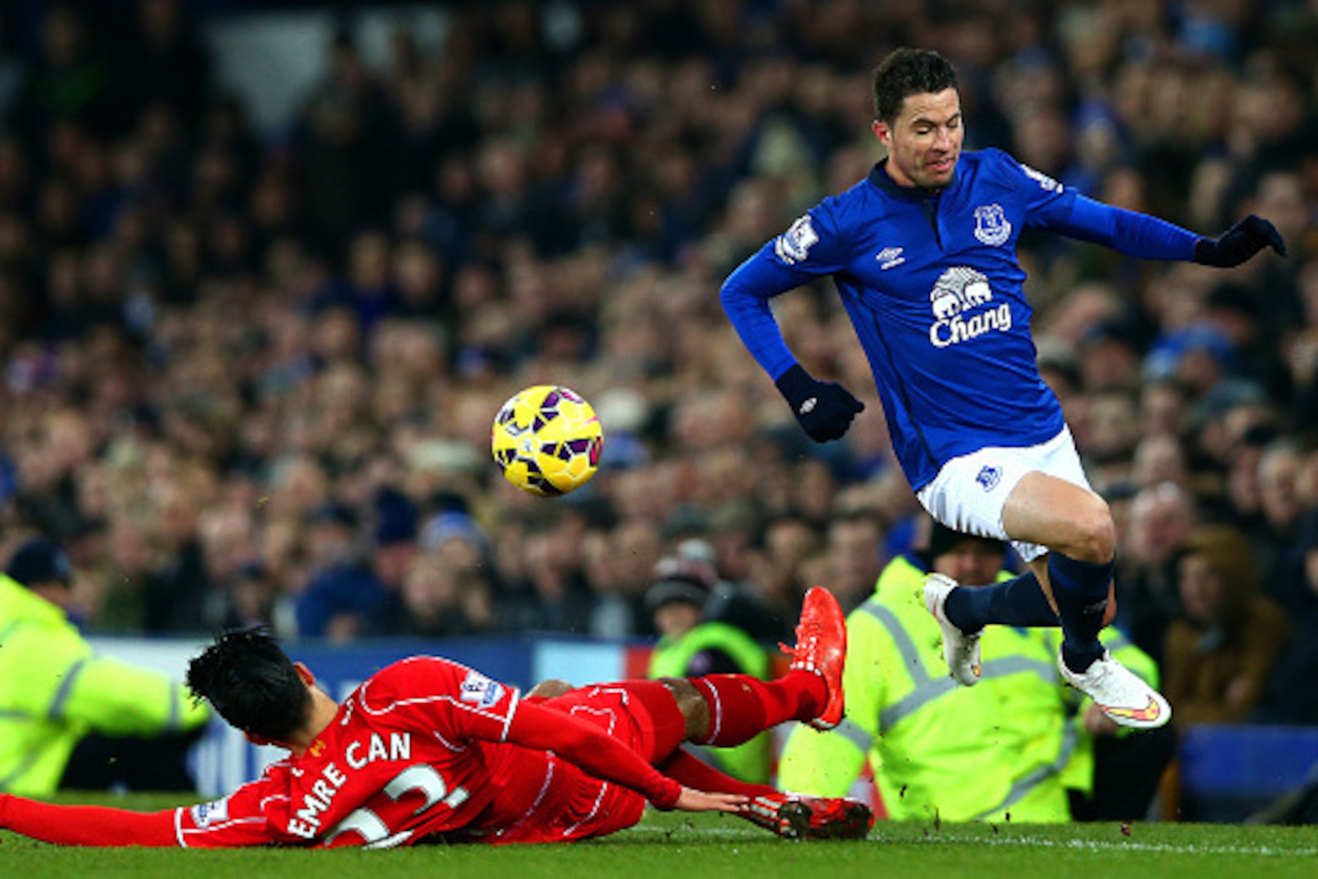 LIVERPOOL, ENGLAND - FEBRUARY 07:  Emre Can of Liverpool slides in on Bryan Oviedo of Everton during the Barclays Premier League match between Everton and Liverpool at Goodison Park on February 7, 2015 in Liverpool, England.  (Photo by Clive Brunskill/Get