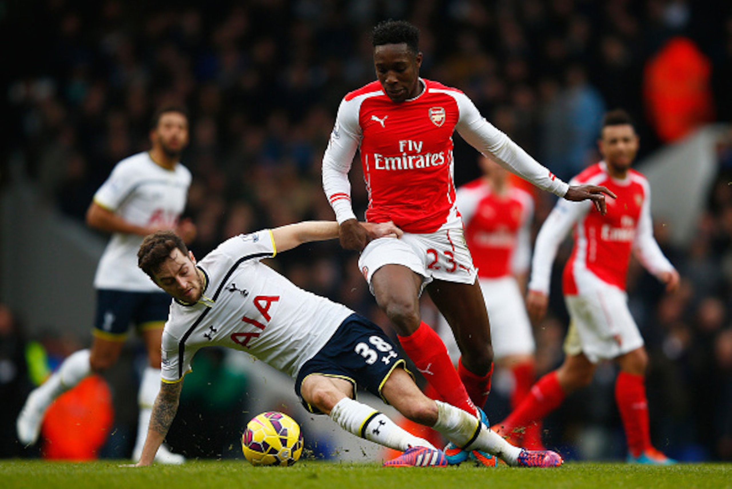LONDON, ENGLAND - FEBRUARY 07: Ryan Mason of Tottenham Hotspur challenges Danny Welbeck of Arsenal during the Barclays Premier League match between Tottenham Hotspur and Arsenal at White Hart Lane on February 7, 2015 in London, England.  (Photo by Clive R