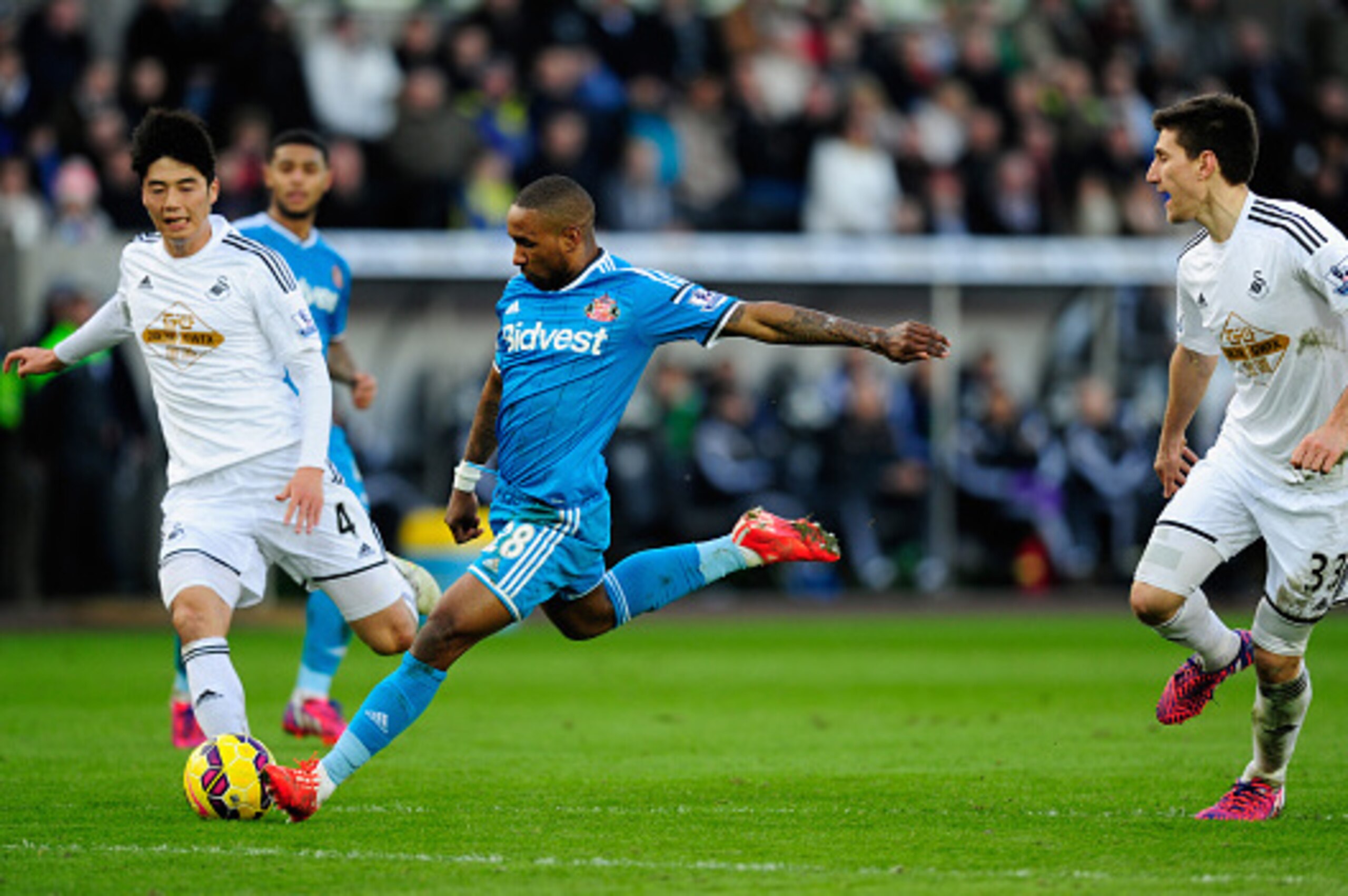 SWANSEA, WALES - FEBRUARY 07:  Sunderland player Jermain Defoe shoots to score the opening goal during the Barclays Premier League match between Swansea City and Sunderland at Liberty Stadium on February 7, 2015 in Swansea, Wales.  (Photo by Stu Forster/G