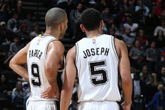 SAN ANTONIO - JANUARY 25:  Tony Parker #9 and Cory Joseph #5 of the San Antonio Spurs talk during the game against the Milwaukee Bucks at the AT&T Center on January 25, 2015 in San Antonio, Texas. NOTE TO USER: User expressly acknowledges and agrees that,