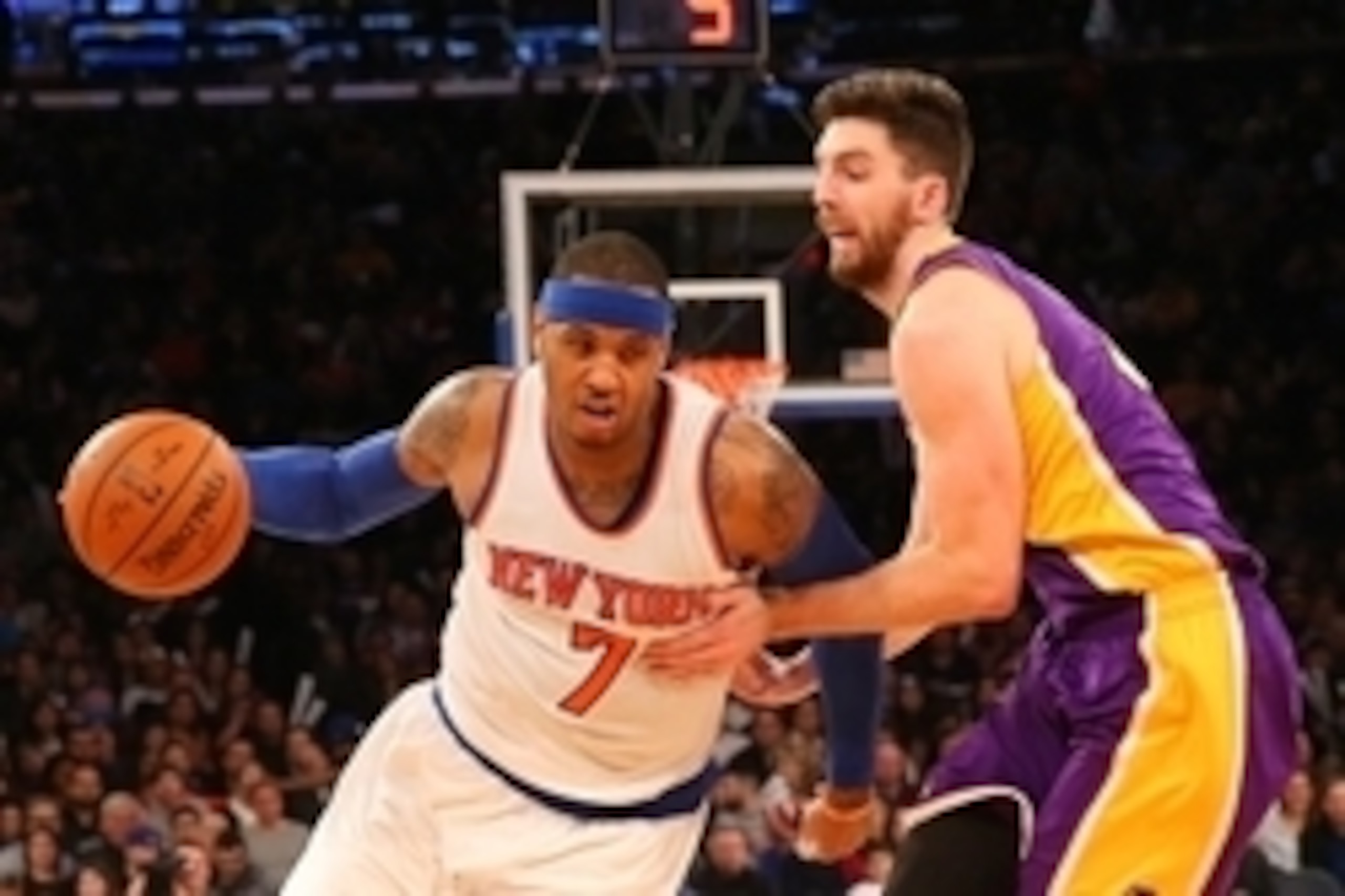 Feb 1, 2015; New York, NY, USA; New York Knicks forward Carmelo Anthony (7) dribbles the ball around Los Angeles Lakers forward Ryan Kelly (4) during the third quarter at Madison Square Garden. The Knicks won 92-70. Mandatory Credit: Anthony Gruppuso-USA