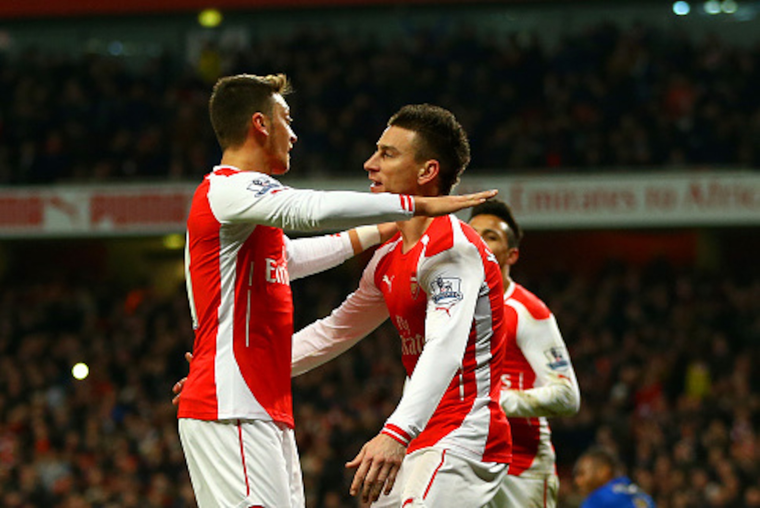 LONDON, ENGLAND - FEBRUARY 10:  Laurent Koscielny of Arsenal celebrates with team-mate Mesut Oezil after scoring the opening goal during the Barclays Premier League match between Arsenal and Leicester City at Emirates Stadium on February 10, 2015 in Londo