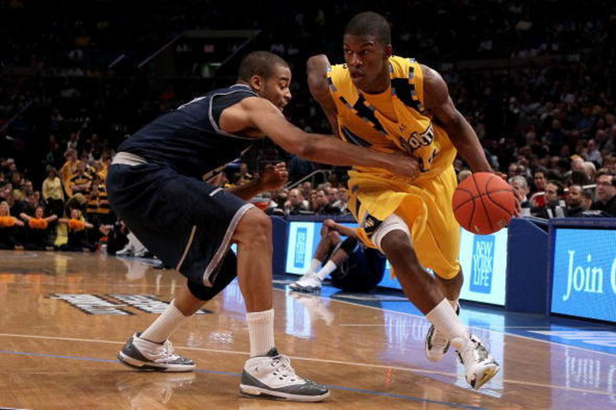 NEW YORK - MARCH 12: Jimmy Butler #33 of the Marquette Golden Eagles handles the ball against Julian Vaughn #22 of the Georgetown Hoyas during the semifinal of the 2010 Big East Tournament at Madison Square Garden on March 12, 2010 in New York City.  (Pho
