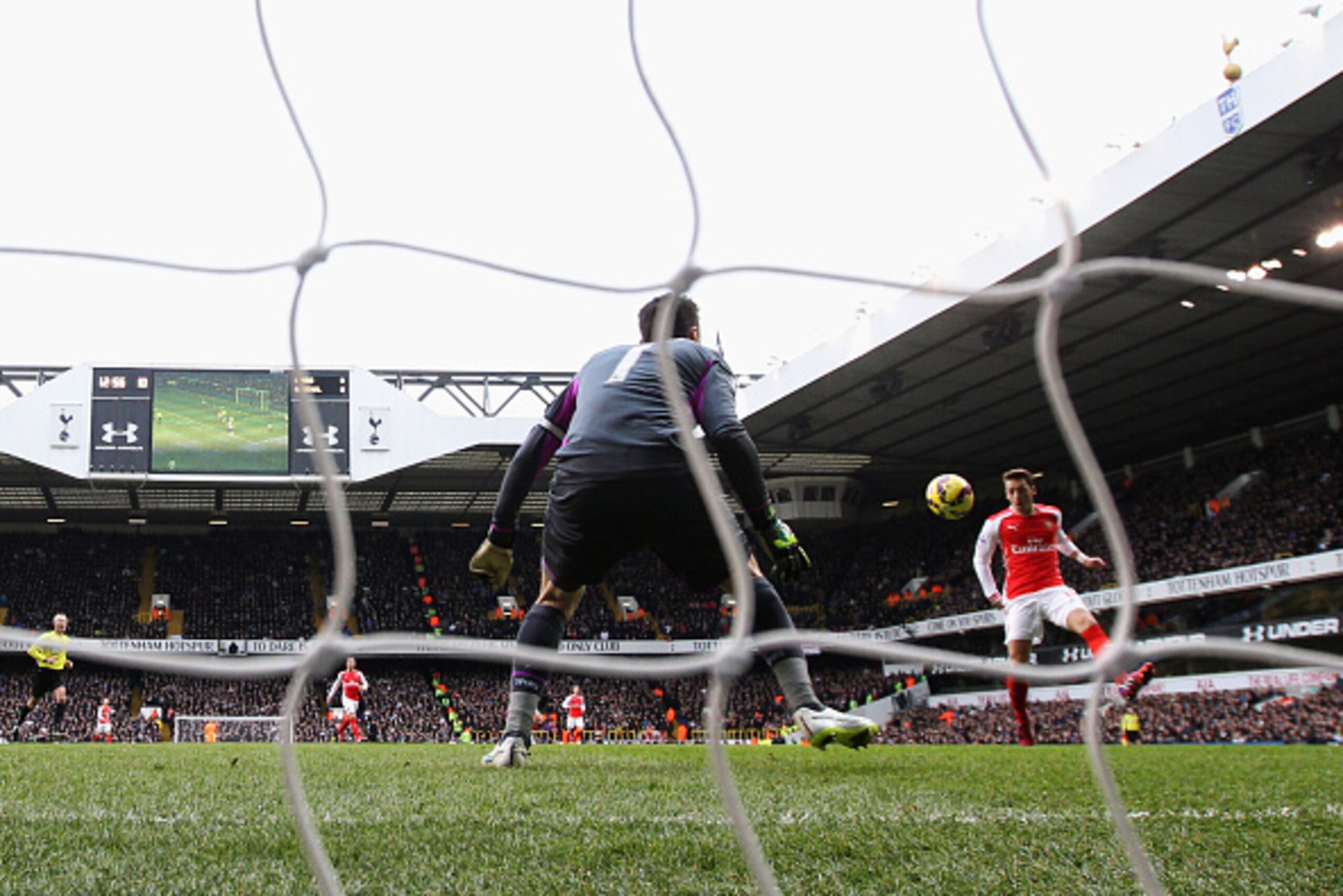 LONDON, ENGLAND - FEBRUARY 07:  Mesut Oezil of Arsenal scores the opening goal during the Barclays Premier League match between Tottenham Hotspur and Arsenal at White Hart Lane on February 7, 2015 in London, England.  (Photo by Clive Rose/Getty Images)