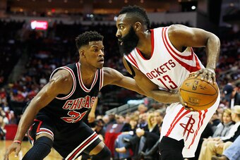 HOUSTON, TX - FEBRUARY 4:   James Harden #13 of the Houston Rockets looks to make a play as Jimmy Butler #21 of the Chicago Bulls defends during their game at the Toyota Center on February 4, 2015 in Houston, Texas..  NOTE TO USER: User expressly acknowle