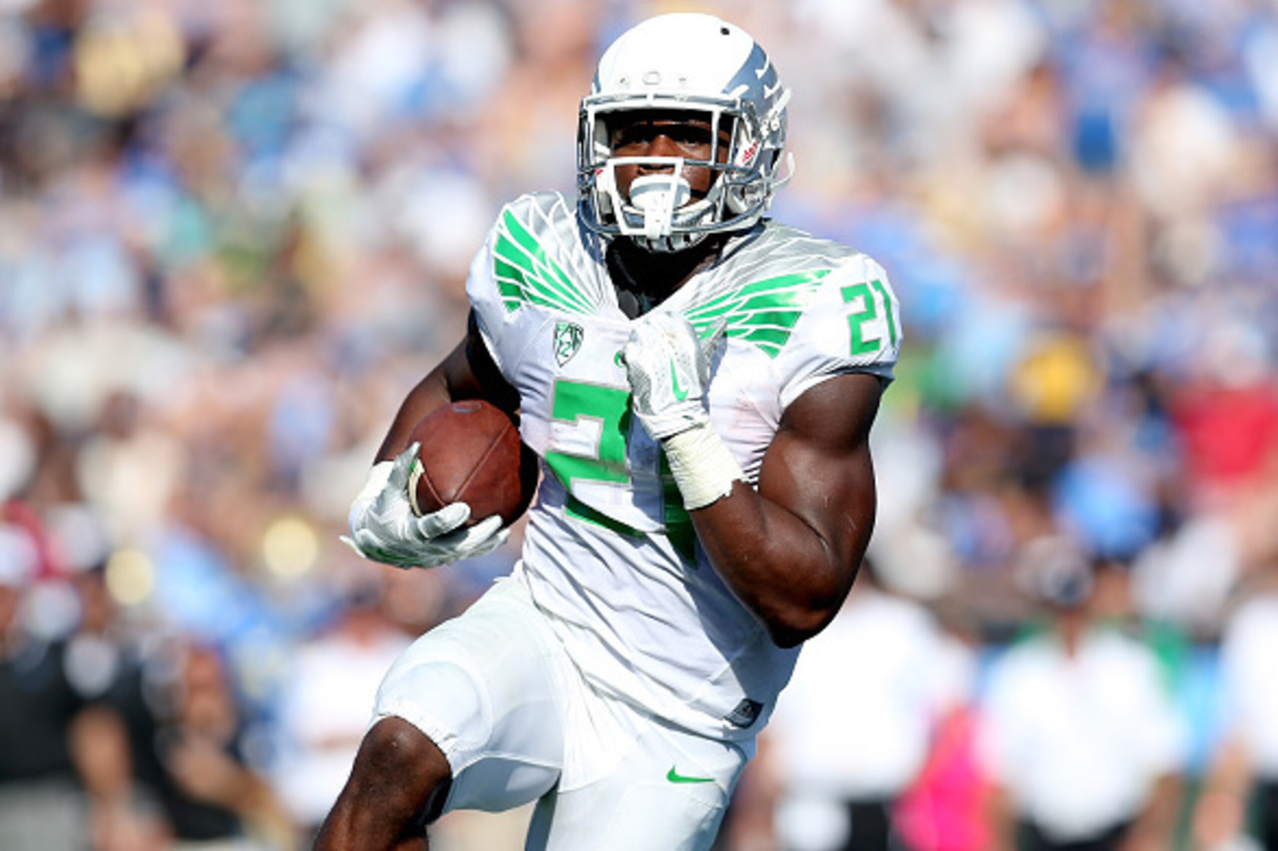 PASADENA, CA - OCTOBER 11:  Running back Royce Freeman #21 of the Oregon Ducks carries the ball on a two yard run for a touchdown in the fourth quarter against he UCLA Bruins at the Rose Bowl on October 11, 2014 in Pasadena, California.  Oregon won 42-30.