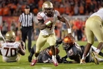 Nov 15, 2014; Miami Gardens, FL, USA; Florida State Seminoles running back Dalvin Cook (4) runs for a touchdown against the Miami Hurricanes during the second half at Sun Life Stadium.  FSU won 30-26. Mandatory Credit: Steve Mitchell-USA TODAY Sports