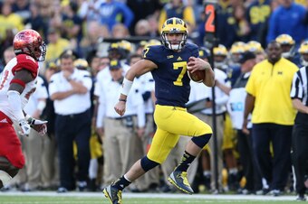 ANN ARBOR, MI - SEPTEMBER 13:  Quarterback Shane Morris #7 of the University of Michigan runs for a first down during the fourth quarter of the game against the Miami University Redhawks at Michigan Stadium on September 13, 2014 in Ann Arbor, Michigan. th