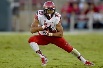 PALO ALTO, CA - NOVEMBER 15:  Devontae Booker #23 of the Utah Utes carries the ball against the Stanford Cardinal in the second quarter at Stanford Stadium on November 15, 2014 in Palo Alto, California.  (Photo by Thearon W. Henderson/Getty Images)