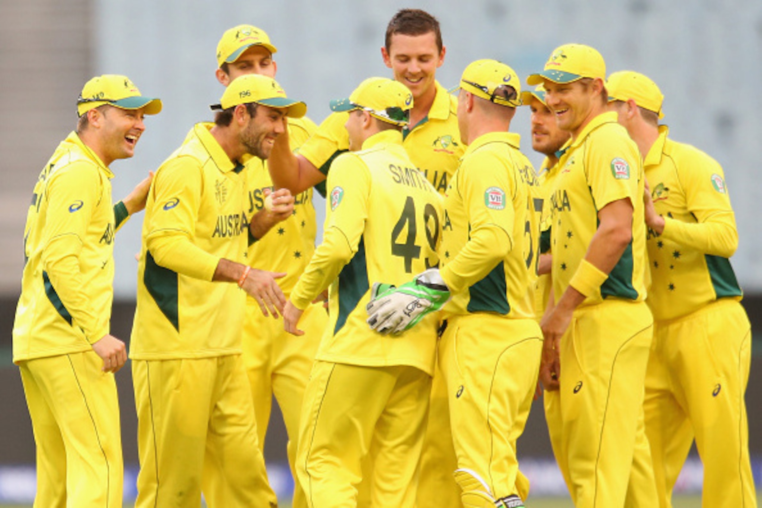 MELBOURNE, AUSTRALIA - FEBRUARY 11:  Michael Clarke of Australia congratulates Glenn Maxwell after he took a catch to dismiss Amjad Ali of the United Arab Emirates as Steven Smith looks on during the Cricket World Cup warm up match between Australia and t