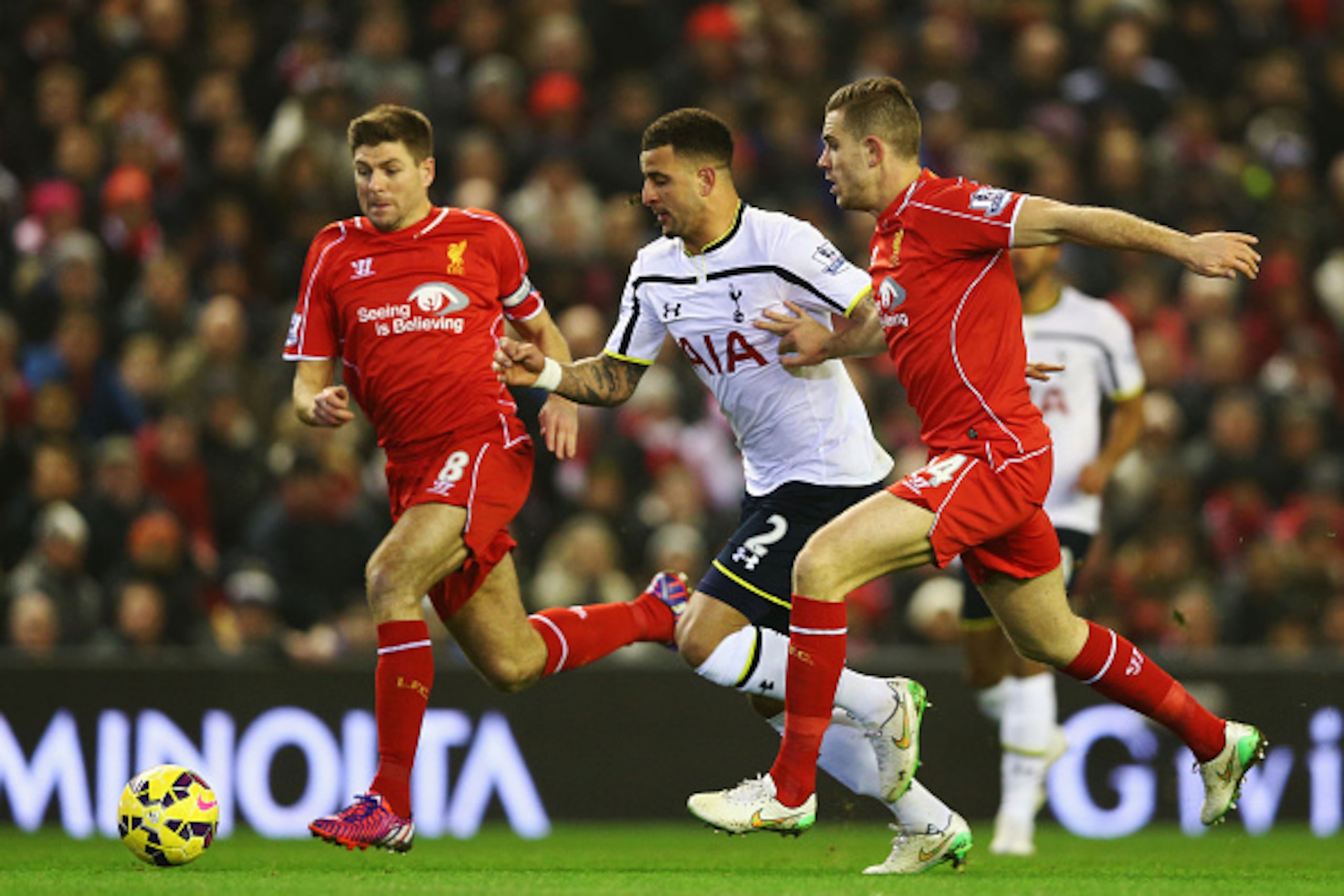 LIVERPOOL, ENGLAND - FEBRUARY 10:  Kyle Walker of Spurs goes between Steven Gerrard and Jordan Henderson of Liverpool during the Barclays Premier League match between Liverpool and Tottenham Hotspur at Anfield on February 10, 2015 in Liverpool, England.  
