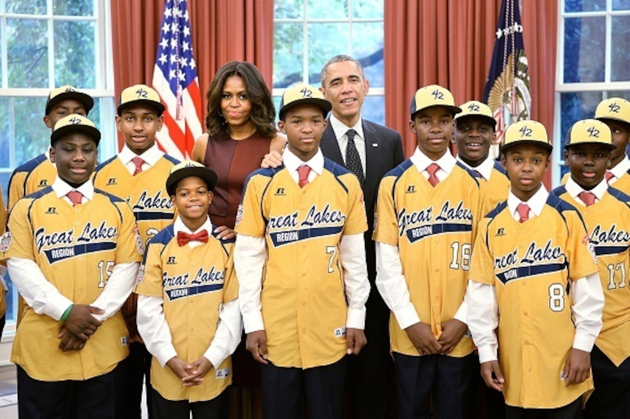 WASHINGTON, D.C. - NOVEMBER 6: (AFP-OUT) U.S. President Barack Obama and first lady Michelle Obama meet with the Jackie Robinson West All Stars in the Oval Office of the White House, November 6, 2014 in Washington, DC. The team won the national championsh