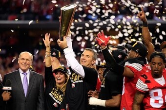 ARLINGTON, TX - JANUARY 12:  Head Coach Urban Meyer of the Ohio State Buckeyes hoist the trophy after defeating the Oregon Ducks 42 to 20 in the College Football Playoff National Championship Game at AT&T Stadium on January 12, 2015 in Arlington, Texas.  