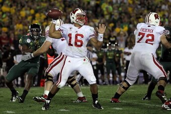 PASADENA, CA - JANUARY 02:  Quarterback Russell Wilson #16 of the Wisconsin Badgers throws the ball against the Oregon Ducks at the 98th Rose Bowl Game on January 2, 2012 in Pasadena, California.  (Photo by Stephen Dunn/Getty Images)