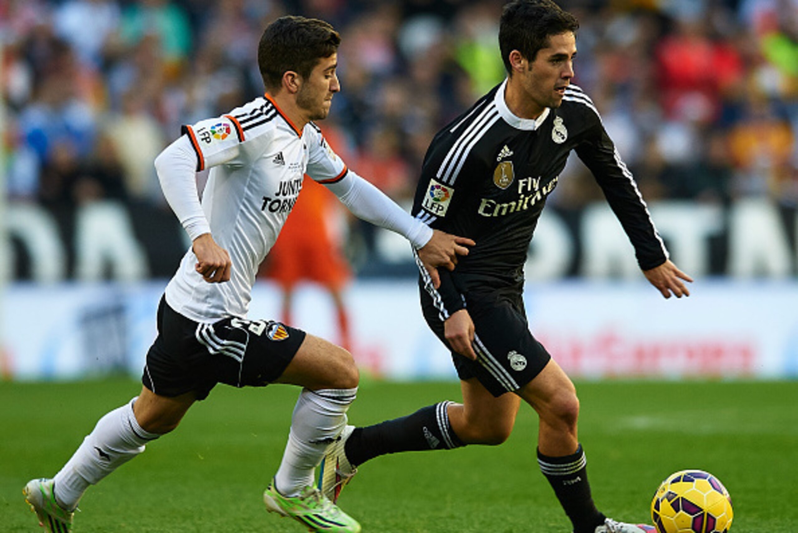 VALENCIA, SPAIN - JANUARY 04:  Jose Gaya (L) of Valencia competes for the ball with Isco of Real Madrid during the La Liga match between Valencia CF and Real Madrid CF at Estadi de Mestalla on January 4, 2015 in Valencia, Spain.  (Photo by Manuel Queimade
