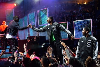 NEW ORLEANS, LA - FEBRUARY 16:  Sean Combs high fives Paul George #24 of the Eastern Conference at the 2014 NBA All-Star Game at Smoothie King Center on February 16, 2014 in New Orleans, Louisiana. NOTE TO USER: User expressly acknowledges and agrees that