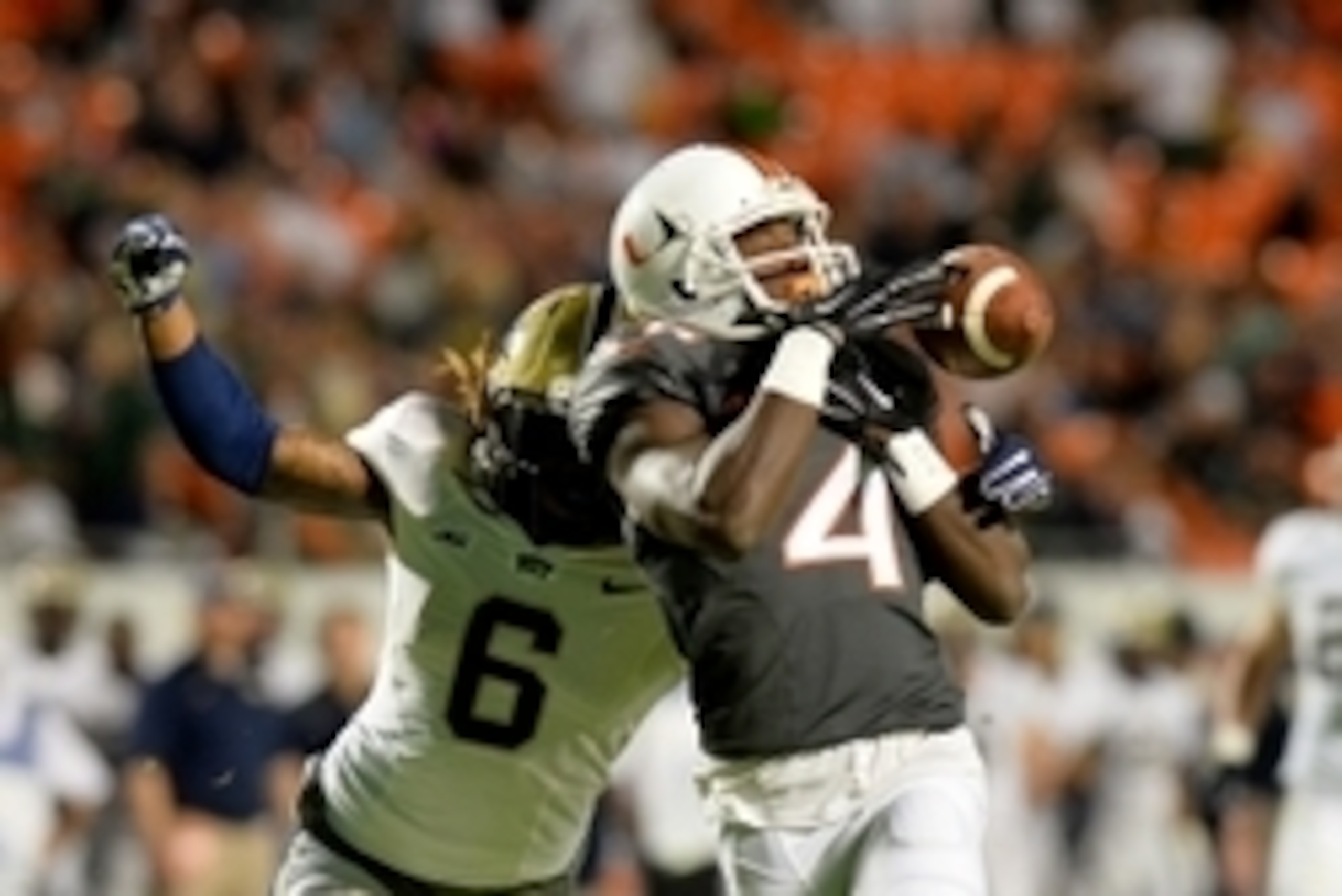 Nov 29, 2014; Miami Gardens, FL, USA; Miami Hurricanes wide receiver Phillip Dorsett (4) attempts to make a catch as Pittsburgh Panthers defensive back Lafayette Pitts (6) defends during the first half at Sun Life Stadium. Mandatory Credit: Steve Mitchell