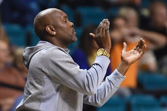 LAS VEGAS, NV - NOVEMBER 24:  Former NBA player Gary Payton claps after his son, Gary Payton II #1 of the Oregon State Beavers, dunked against the Oklahoma State Cowboys during the 2014 MGM Grand Main Event basketball tournament at the MGM Grand Garden Ar